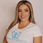 Woman wearing a white t-shirt with the words "Metamorphosis ABA Therapy".