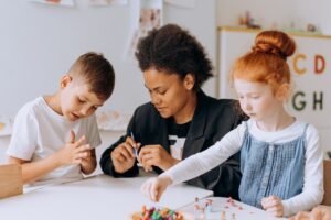 Woman and two children playing with toys