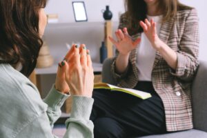 Two women clapping on a couch, ABA therapy