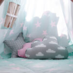 Cozy calming corner with soft star and cloud pillows for child-led play and emotional regulation in ABA therapy