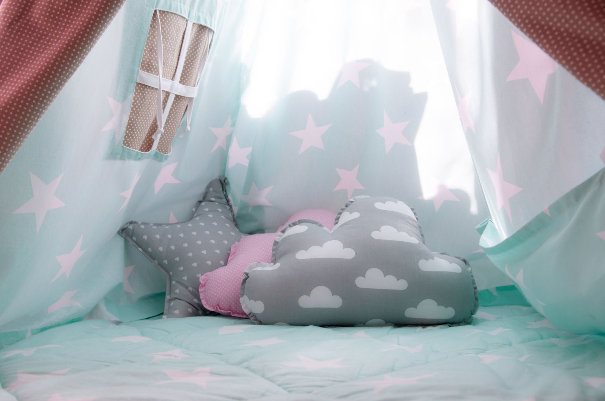 Cozy calming corner with soft star and cloud pillows for child-led play and emotional regulation in ABA therapy