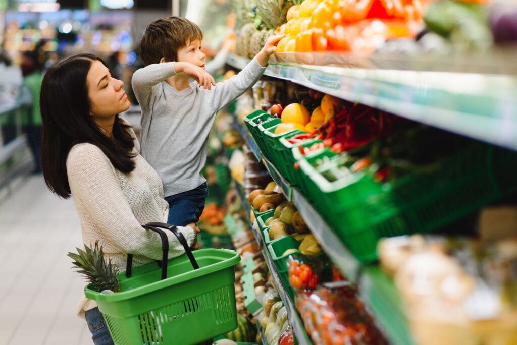 Mother shopping with her young son in a grocery store